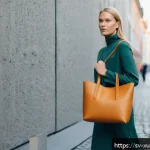 악세서리 브랜드의 지속가능성을 위한 협력 - A stylish Scandinavian woman carrying a sustainable handbag made from mycelium leather, standing in ...